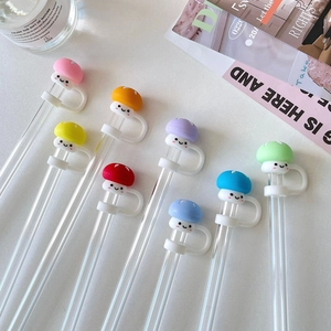 Detailed set of 8 glass pens with colorful silicone mushroom caps on a white desk