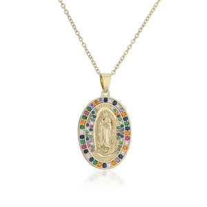 Macro shot of gold Virgin Mary pendant with colorful zircon stones and polished finish