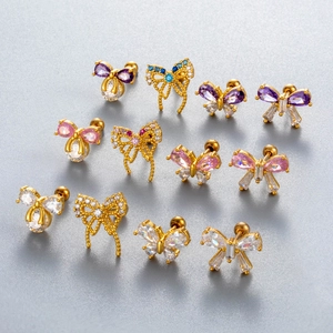 Detailed macro view of 12 bow and butterfly stud earrings with gold plating and zircons