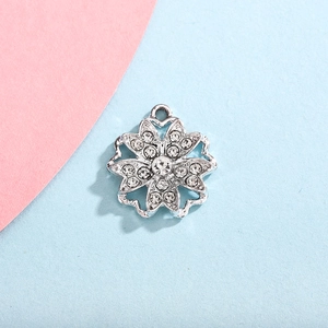 Detailed macro of a silver snowflake pendant with sparkling rhinestones for jewelry DIY