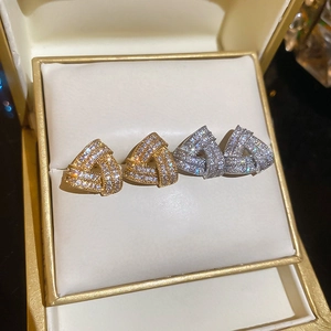 Detailed view of geometric triangle stud earrings with zircons in gold and silver finish