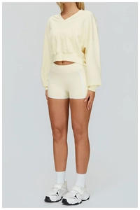 Front view of light yellow long sleeve V-neck sweatshirt and matching yoga shorts set