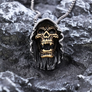 Retro punk hooded reaper skull pendant in silver and gold steel on dark rock background