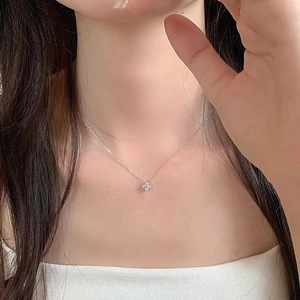 Detail of S925 sterling silver four-leaf clover necklace with sparkling cubic zirconia
