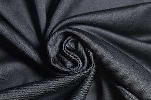 Macro shot showing the texture and drapery of black knitted fabric for backless dress