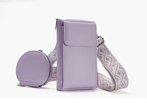Detail of light purple litchi grain faux leather crossbody bag with jacquard strap