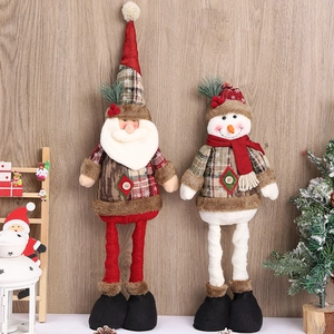 Standing telescopic Santa and Snowman plush dolls on wooden background for Xmas decor