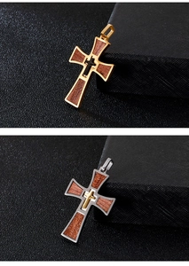 Detail of cross pendants with wood inlay and polished stainless steel metallic frames