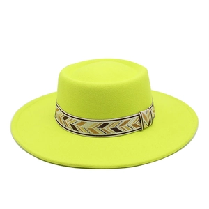 Detail of wool felt boater hat featuring a woven geometric patterned band and wide flat brim