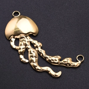Detailed view of gold irregular jellyfish pendant with wavy textures on black background