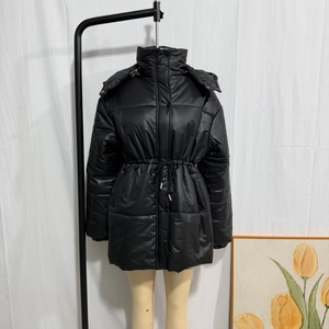 Detail of black hooded winter coat with adjustable drawstring waist on a mannequin
