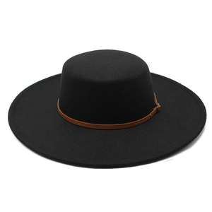 Detail of black flat top wool felt hat with a brown leather band and metal buckle strap
