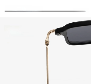Detailed macro view of the reinforced metal hinges and gold temples on fashion sunglasses