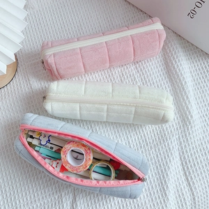 Soft quilted plush pencil cases in pink, white, and gray with large storage capacity