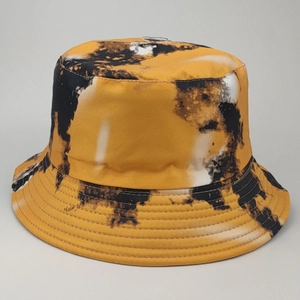Detail of yellow and black tie-dye bucket hat showing stitching on the reinforced brim