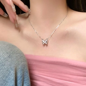 Silver butterfly pendant necklace with strawberry quartz shown on neck, elegant design