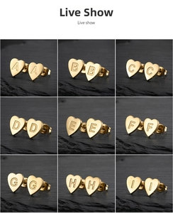 Detailed grid of gold heart-shaped initial earrings A-I with brushed metal texture