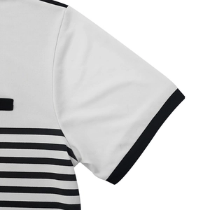 Detailed view of the striped polo shirt showing fine knit texture and reinforced stitching