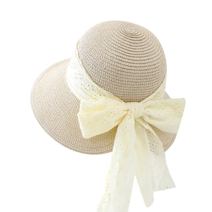 Summer straw sun hat for women with elegant cream lace ribbon and large bow detail