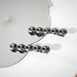 Set of two silver-gray metal chain link hair clips with a polished high-gloss finish