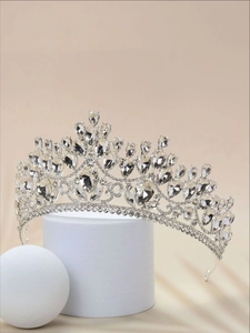 Macro shot of silver bridal crown featuring teardrop rhinestones and detailed scrollwork