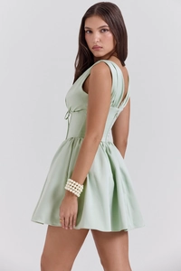 Detail of light green satin mini dress showing cinched waist and pleated A-line skirt