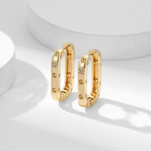 Elegant gold rectangular hoop earrings with micro-pave cubic zirconia on a white pedestal