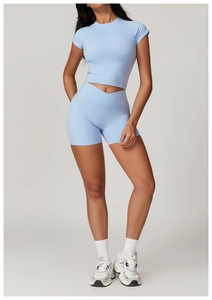 Detail of light blue yoga set featuring a cross-waist high-rise short and cropped top
