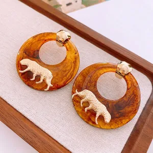 Vintage amber resin hoop earrings with golden tiger relief for a retro luxury aesthetic