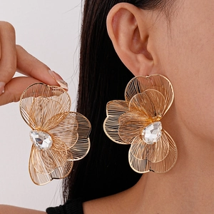 Golden oversized hollow wire flower earrings with teardrop crystal and model display