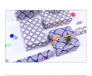 Detail of dark blue Japanese fan pattern gift wrapping paper with decorative twine