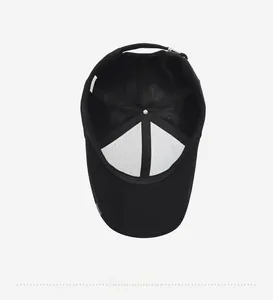 Interior view of black cotton baseball cap showing lining and adjustable buckle
