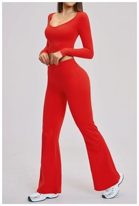 Detail of red two-piece yoga set featuring cropped long sleeve top and flared leggings