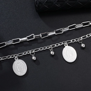 Close-up of Virgin Mary pendants on double-layered stainless steel chain bracelet
