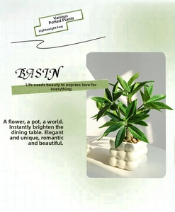 Detailed view of artificial green plant in a white textured ceramic pot with pebbles