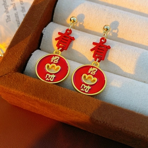 Detail of vintage Chinese style enamel earrings with lucky symbols in gold and red finish