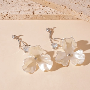 Detail of flower earrings with pearl finish petals and sparkling zircon studs