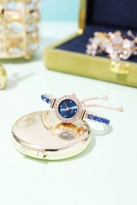 Detail of rose gold ladies' watch with blue dial and diamond-encrusted bracelet link