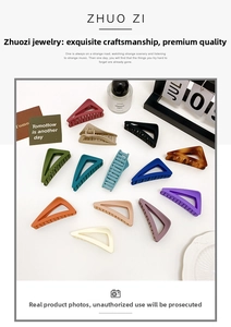 Flat lay of minimalist matte and amber triangle hair claws in thirteen vibrant colors