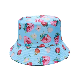 Close-up of light blue cotton fisherman hat with strawberry and floral prints and fine stitching