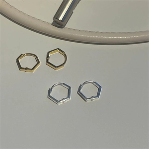 Minimalist geometric hexagonal earrings set in polished gold and silver metallic finishes