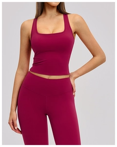 Detail of burgundy ribbed racerback sports bra showing stretchy fabric and square neckline