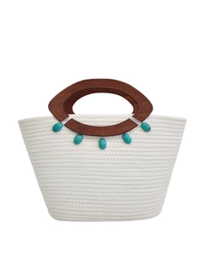 White woven tote bag featuring round wooden handles and turquoise stone embellishments