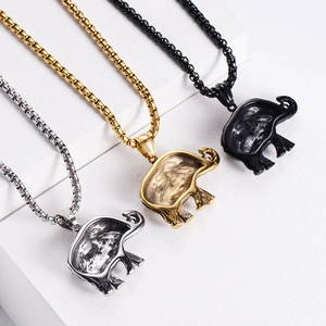 Detailed comparison of vintage elephant pendants in silver, gold, and black finishes
