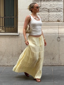 Yellow tiered maxi skirt with elastic drawstring waist and layered ruffle design