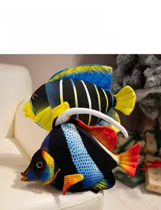 Detailed view of colorful plush tropical fish pillows on a soft white sofa set