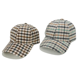 Detail of wool blend baseball caps showing British retro plaid patterns and thick texture