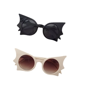 Unique bat-shaped fashion sunglasses in black and cream with round lenses and wings