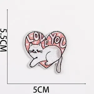 Detailed view of heart-shaped cat patch showing 5.5cm by 5cm dimensions and love embroidery