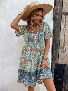 V-neck bohemian floral dress in green with orange flowers for casual vacation style